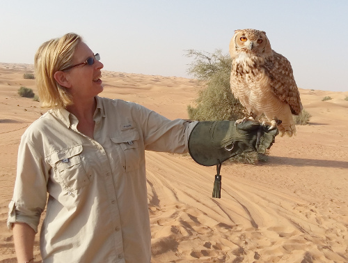 Leslie holding a desert eagle owl.