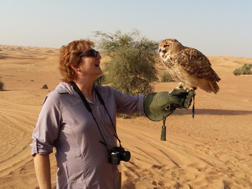 Mary holding a desert eagle owl.