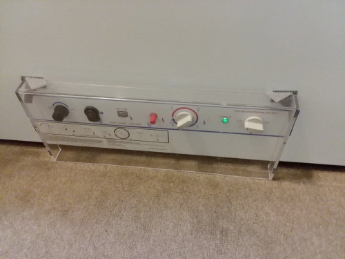 A clear plastic guard covering the freezer controls.