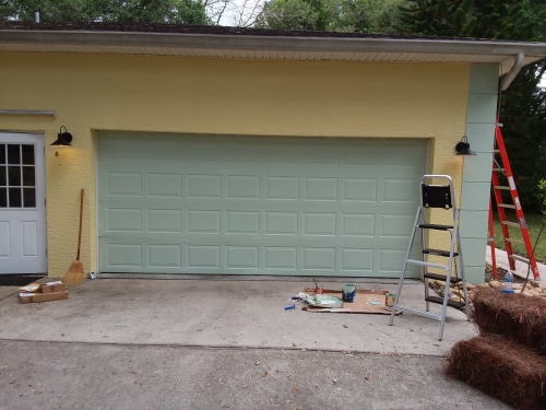 The garage door and corner trim are painted.