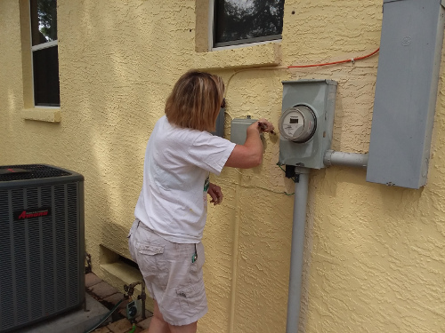 Leslie Painting the east side of the house.