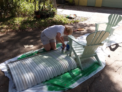 Leslie paining an awning.