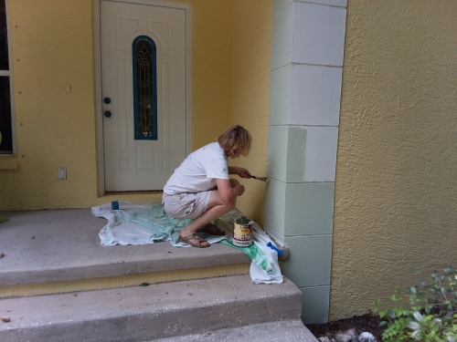 Leslie painting the front porch trim.
