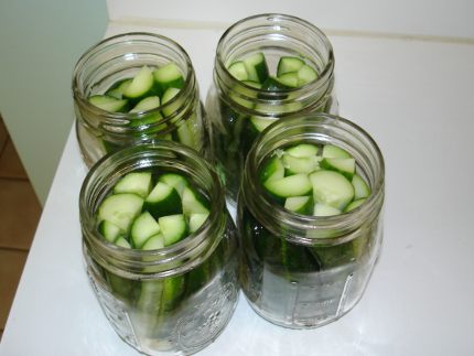The cucumbers packed into the jars.