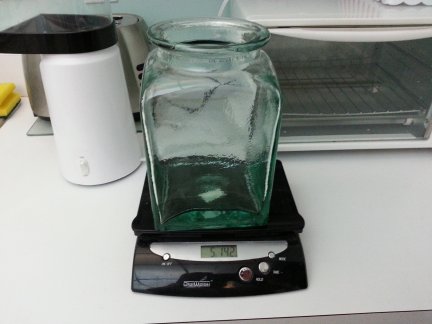 A large green glass storage container.