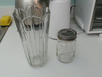 A clear glass vase and a Mason jar.