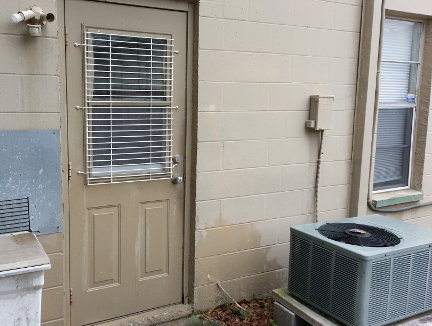 A security grid installed on the window of the side door to the garage.