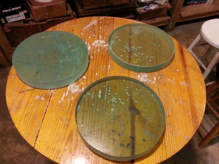 Three finished 10 inch diameter mirror blanks.