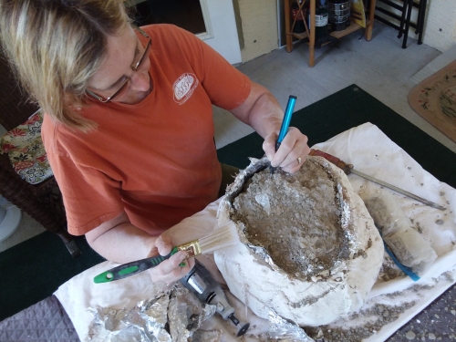 Carefully exposing fossil bones.