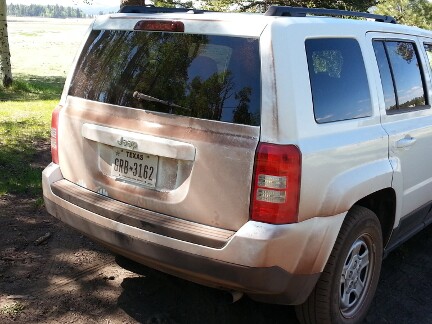 My rented white Jeep all covered with brown trail dust.