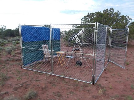 A dog kennel being used as a wind break for my telescope.