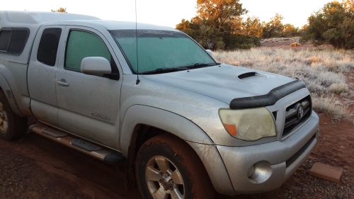 My truck covered in frozen mud and frost.