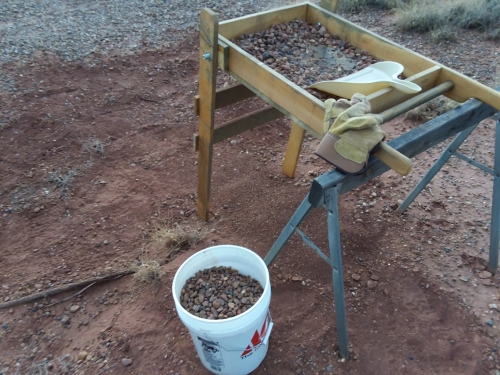Filling buckets with gravel.