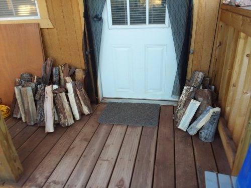 Firewood stacked on the front porch of my cabin.