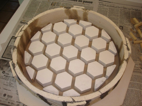 A mold for casting a honeycomb telescope mirror.